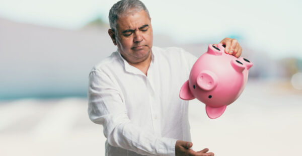 Man shakes empty piggy bank