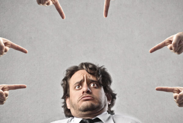 Accusing fingers point at man