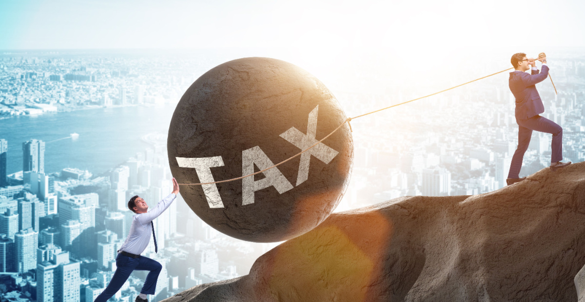 Men pushing boulder up steep hill