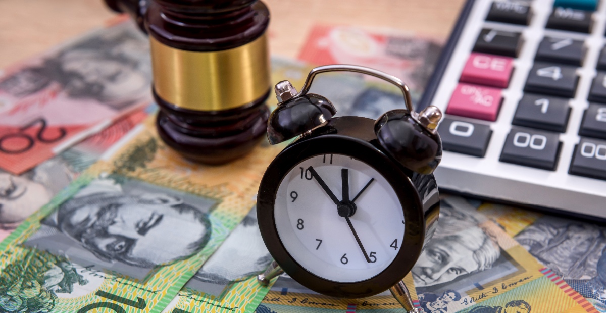 Australian bank notes, gavel and clock