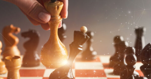 Hand pushes white chess piece