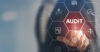 Finger touches audit button