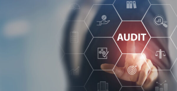 Finger touches audit button