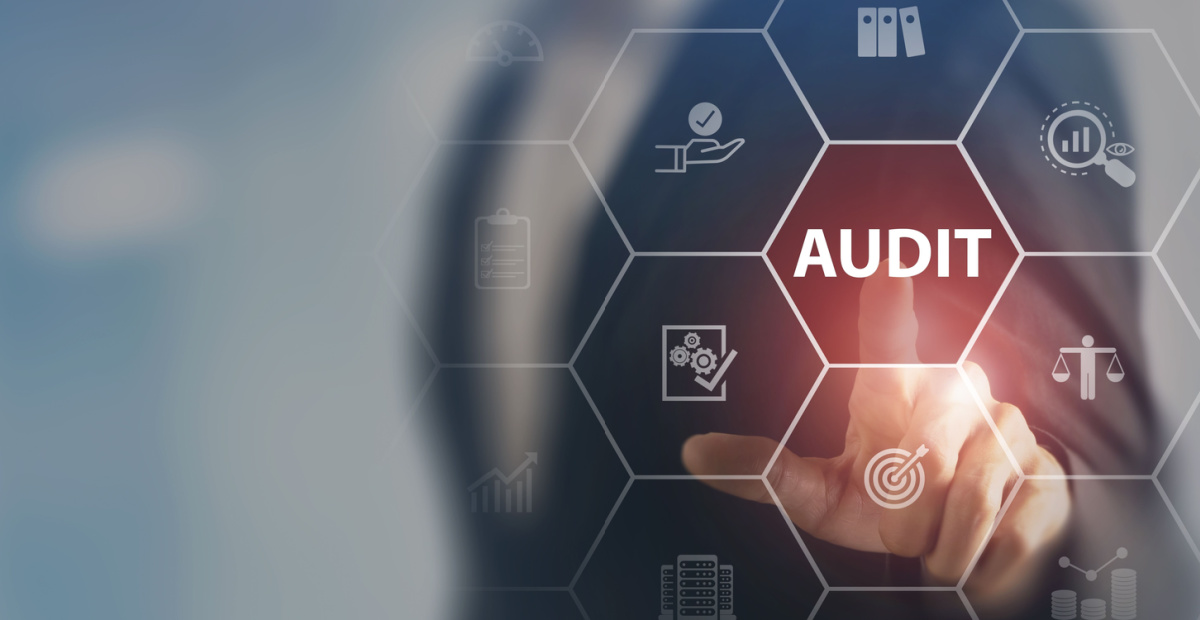 Finger touches audit button