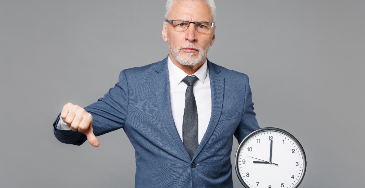 Unhappy older dude with clock