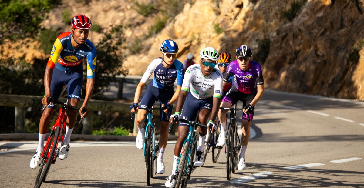 Cyclists climbing hill