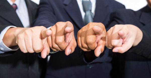 Accusing fingers pointing