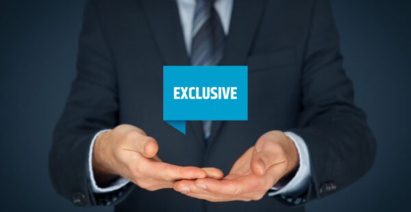 Suited man cups exclusive sign