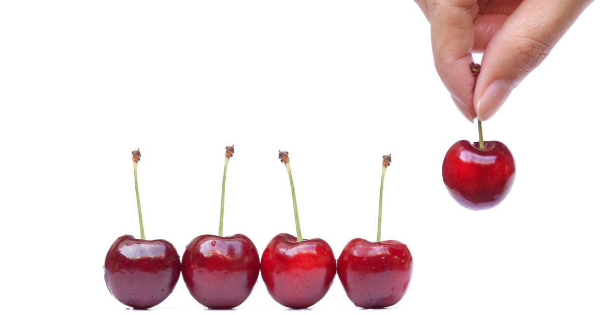 Hand picks a cherry