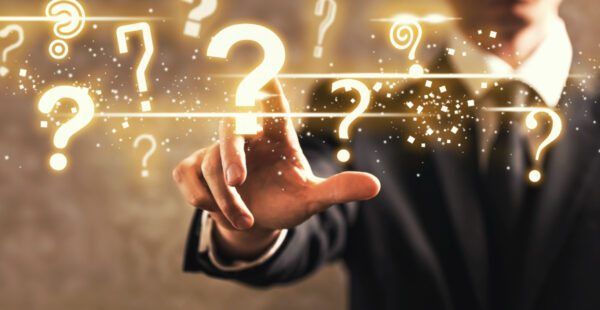 Man's finger on question mark