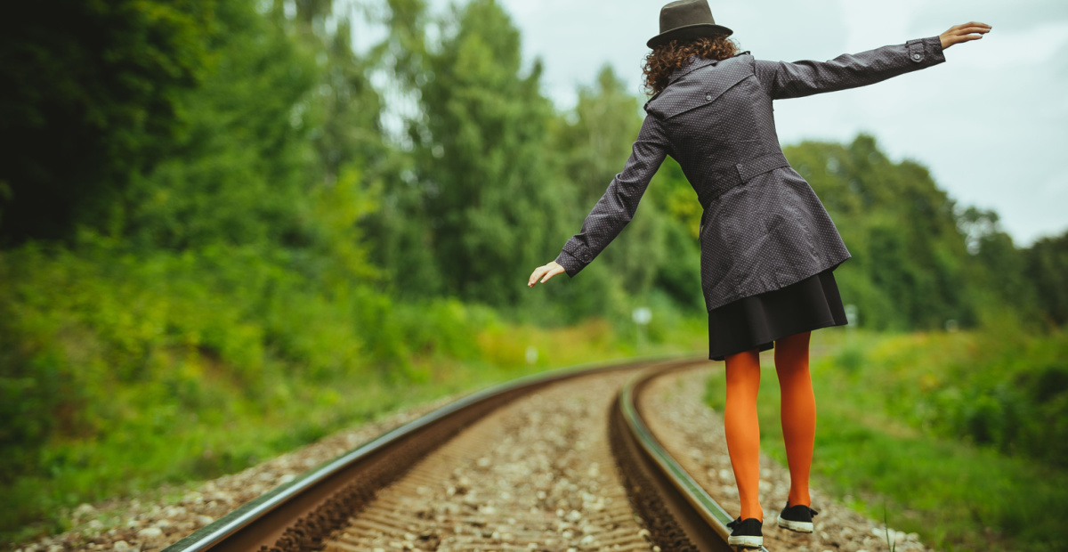 Woman balancing on a rail