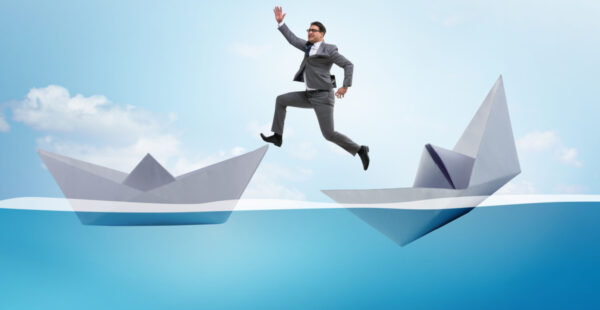 Man jumping paper boats