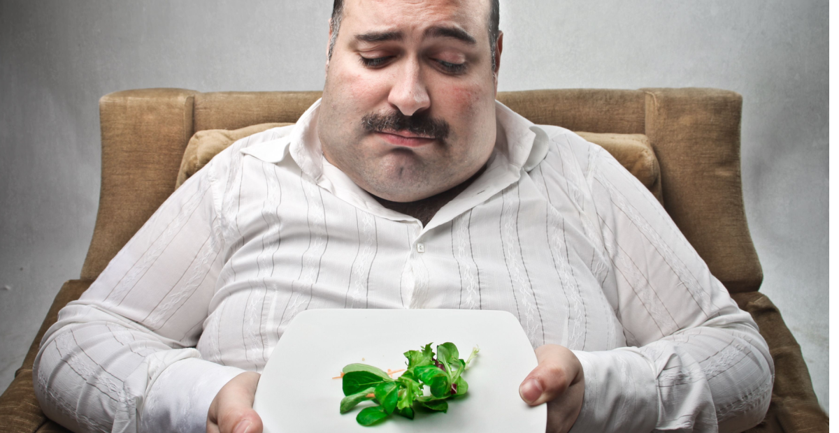 Disappointed fat man with lettuce