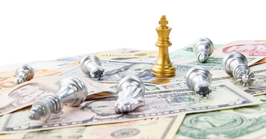Gold Chess piece last piece standing on top of money