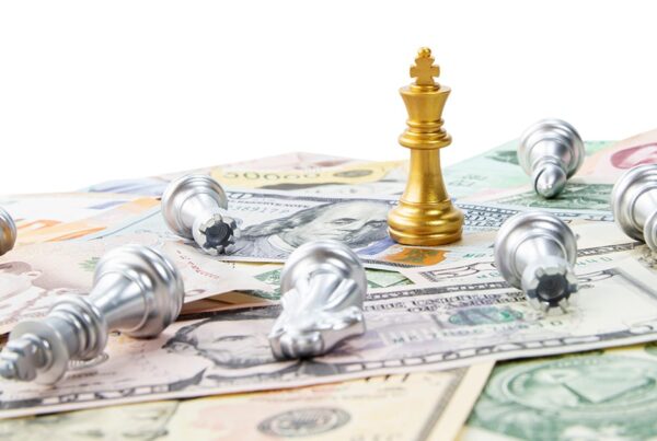 Gold Chess piece last piece standing on top of money