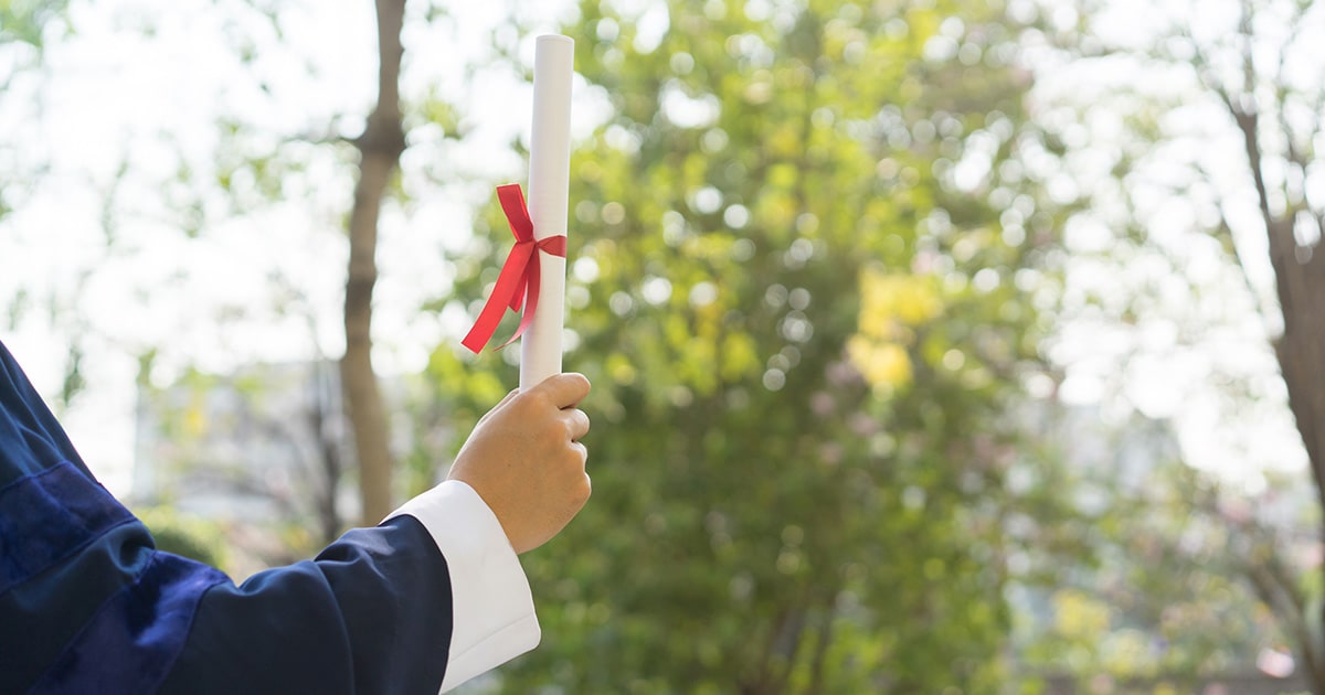 Graduate holding diploma