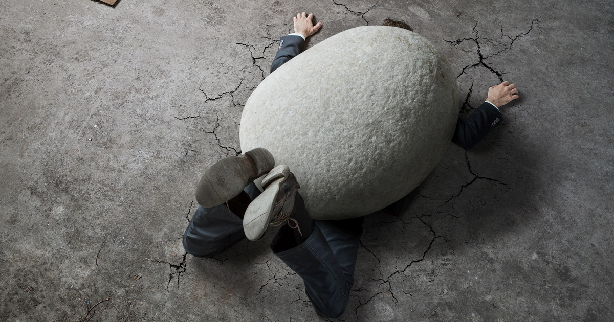 Man crushed by stone with cracks in the ground