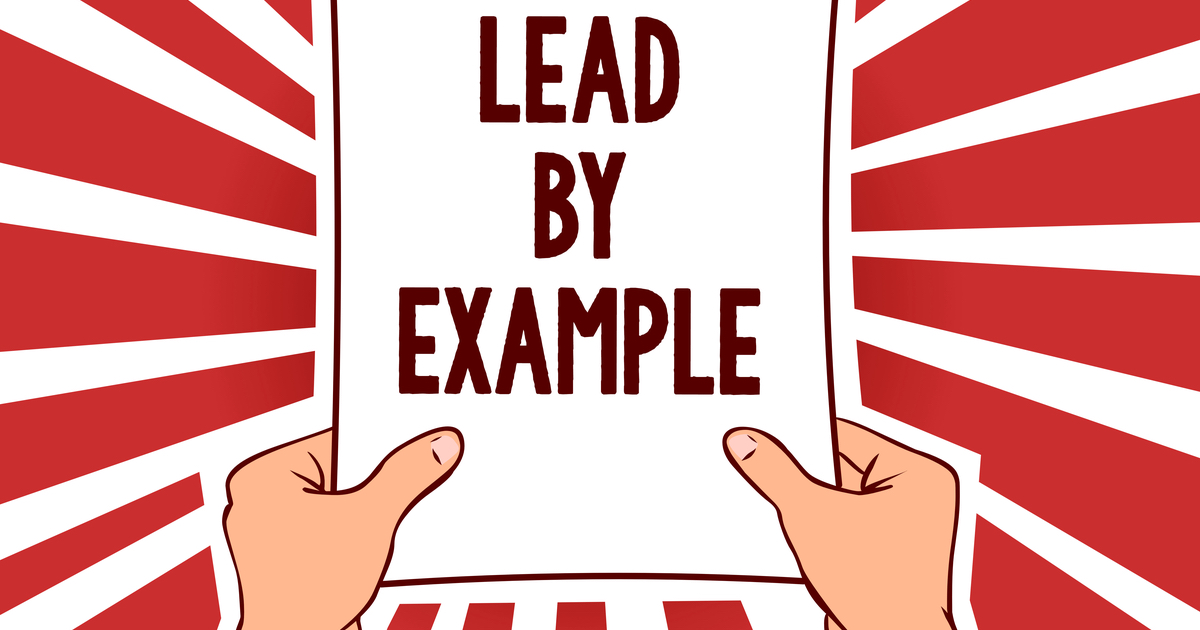 Graphic with hands holding sign with Lead By Example written