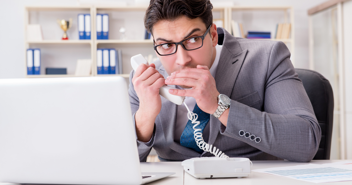 Businessman secretly talking on the phone