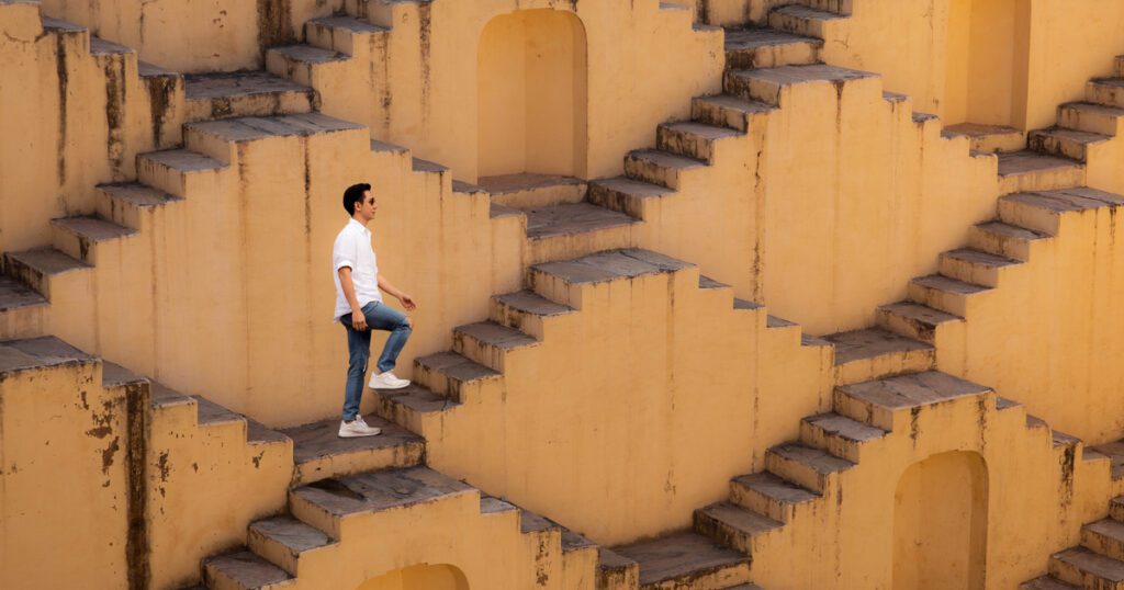 Man stepping up flights of stairs