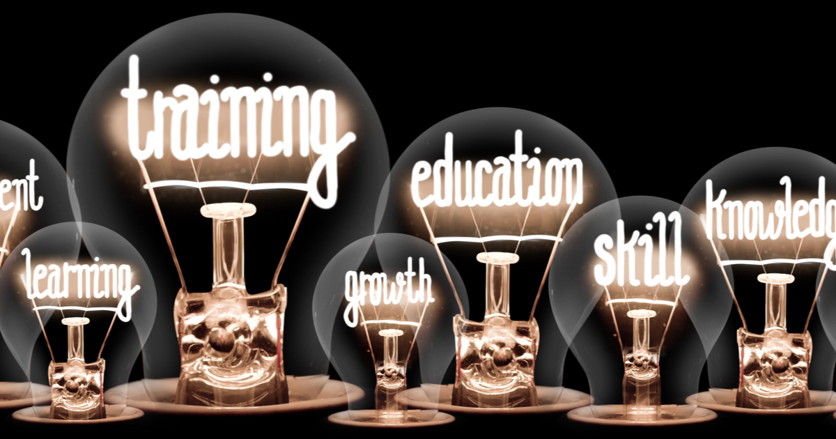 Light bulbs with various words inside them such as training, education, growth, skill