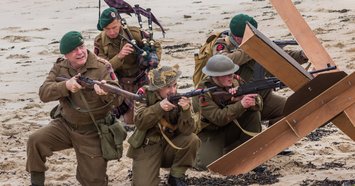 Soldiers with guns on beach