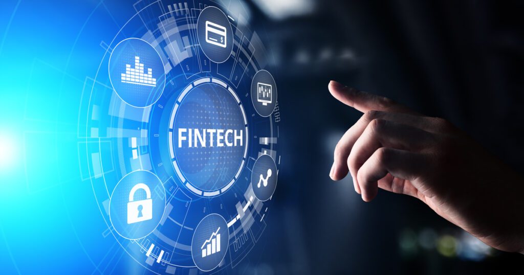A finger about to touch the word Fintech with tech icons