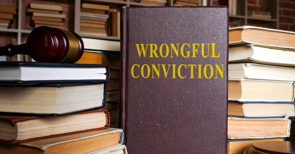 Book with Wrongful Conviction written on it next to a gavel on a pile of books