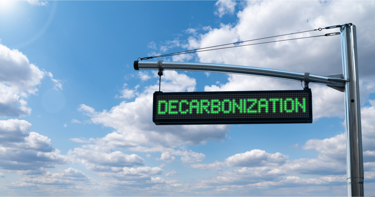 Electric sign saying 'Decarbonisation' with blue sky
