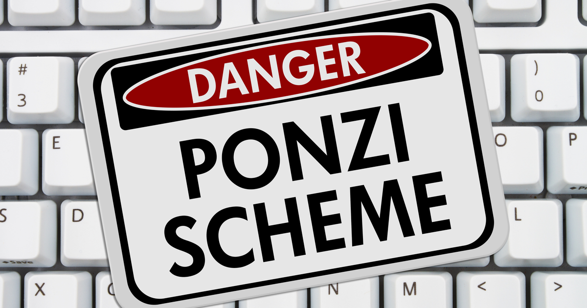Sign with 'Danger Ponzi Scheme' on top of keyboard