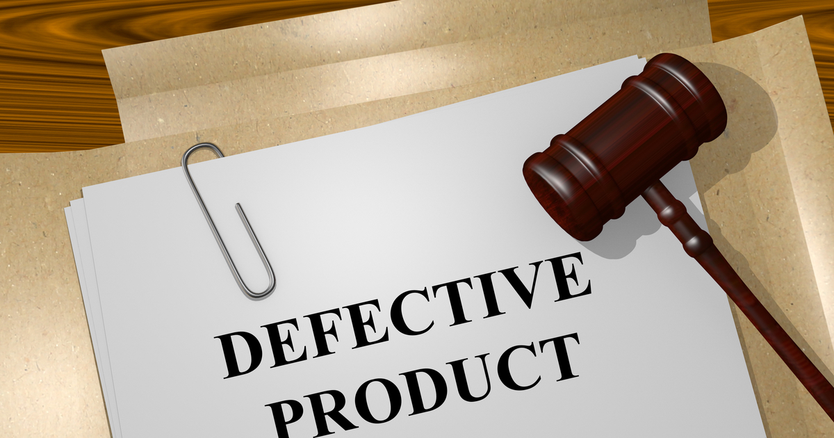 Paper with 'Defective Product' written on it next to a gavel