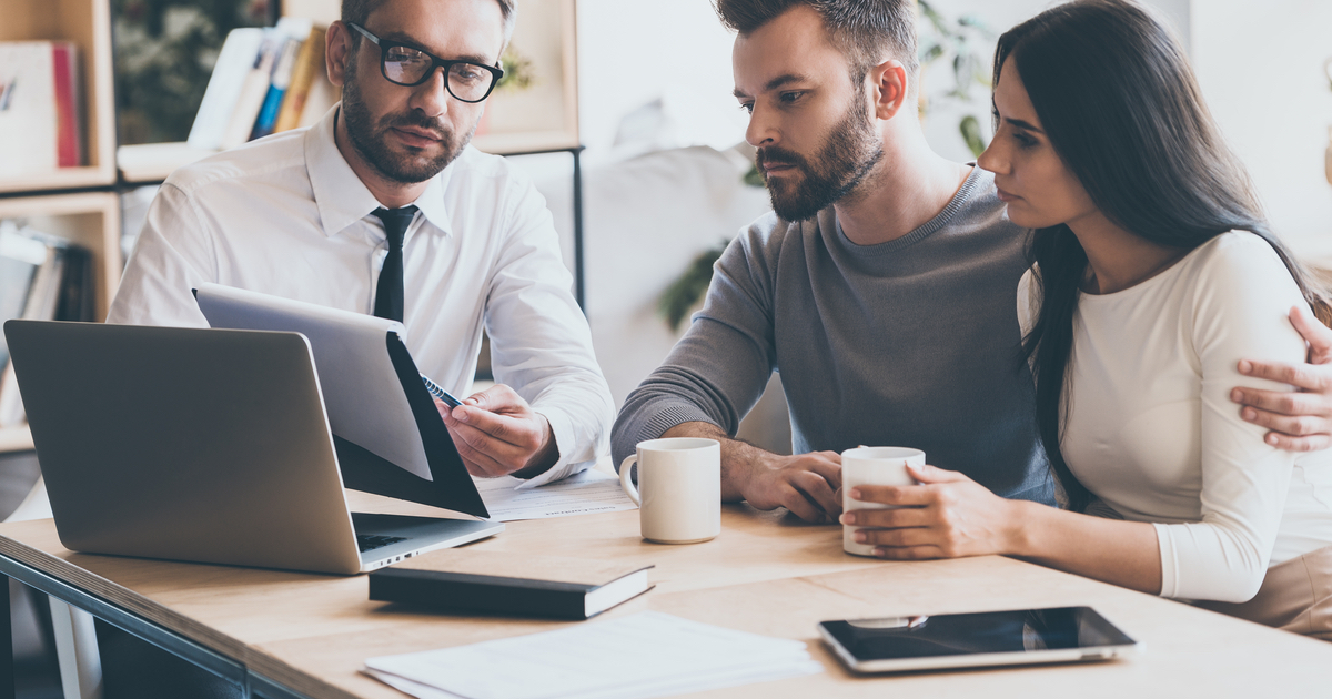 Financial adviser sitting with couple talking through options