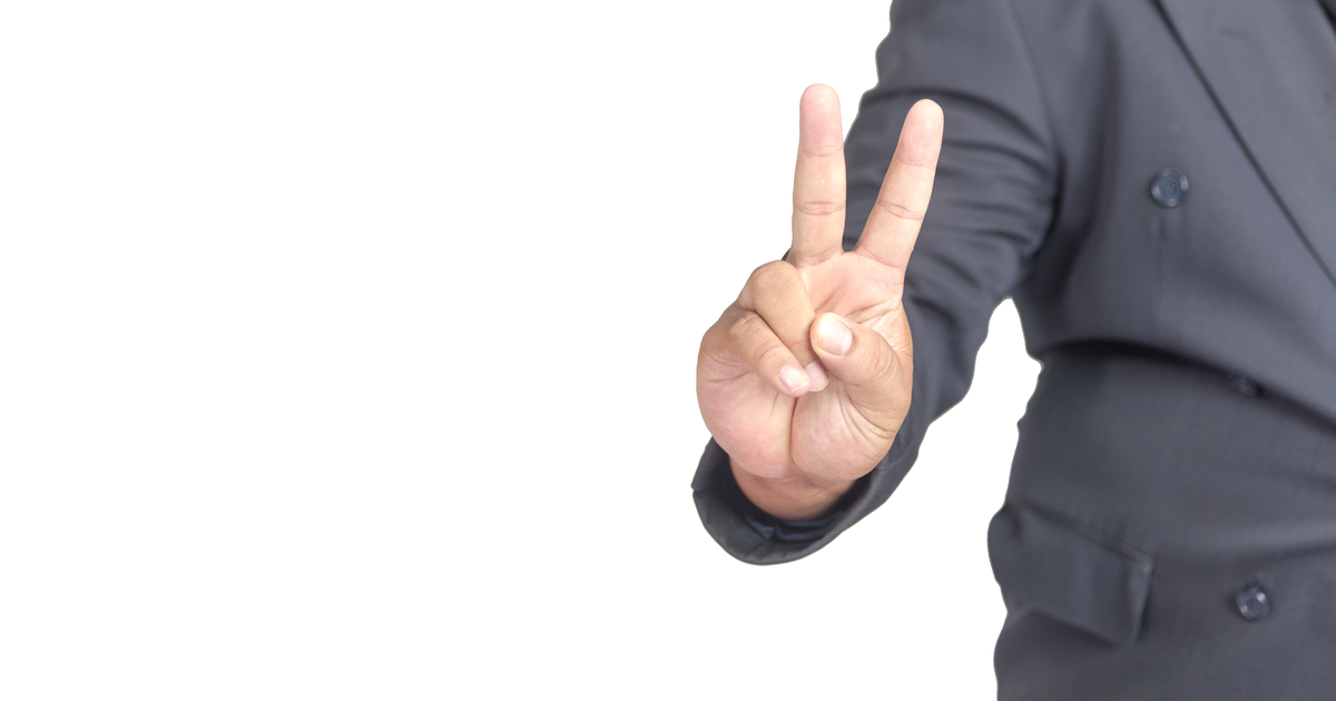 Businessman showing the number two with fingers