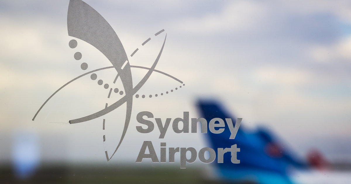 Sydney Airport logo with blurred planes in background